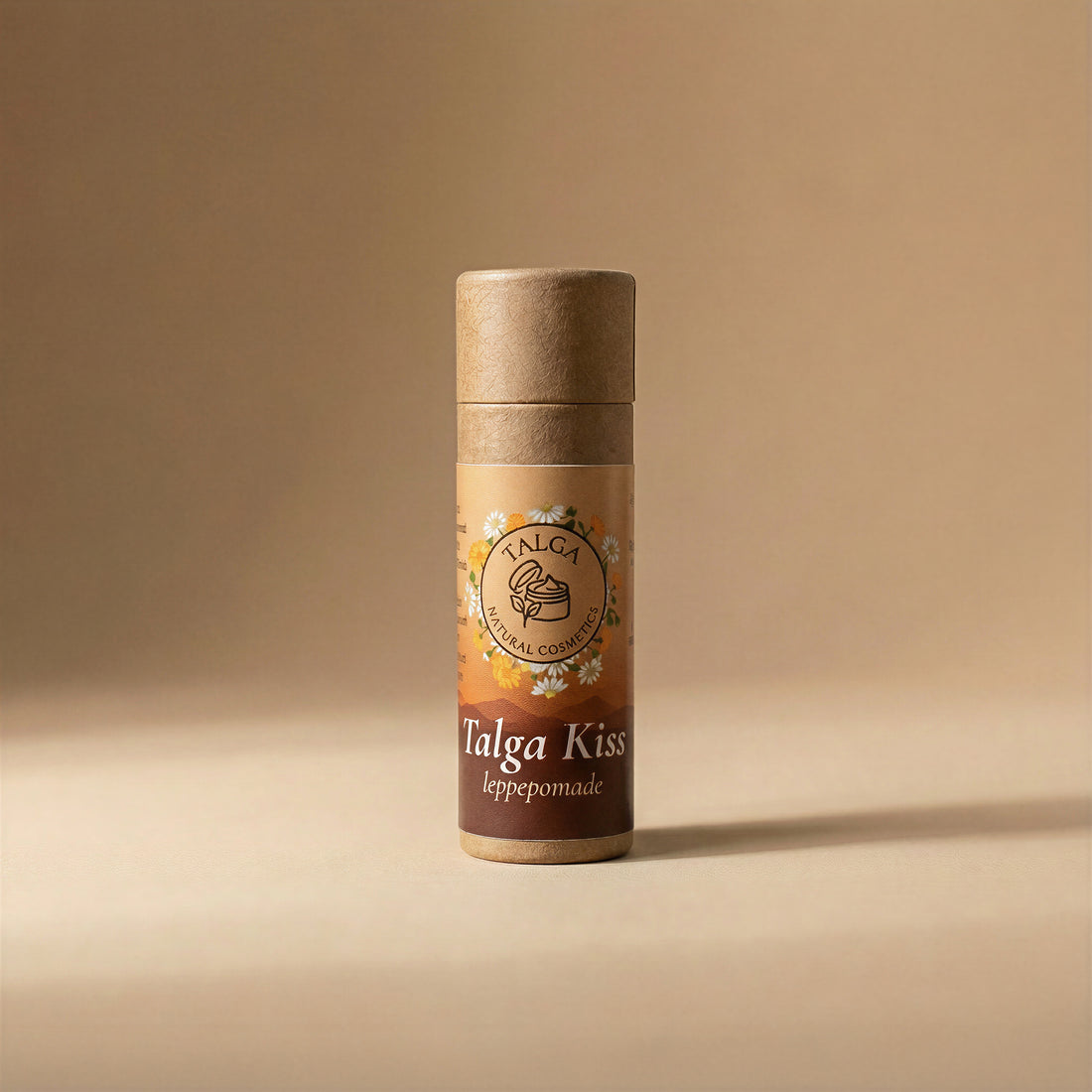 Front view of Talga Kiss leppepomade tallow lip balm in a paper tube on a beige background.