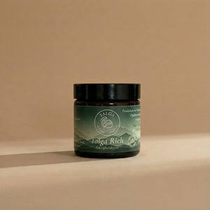 Talga Rich moisturizing cream in an amber glass jar with a black lid on a beige background.