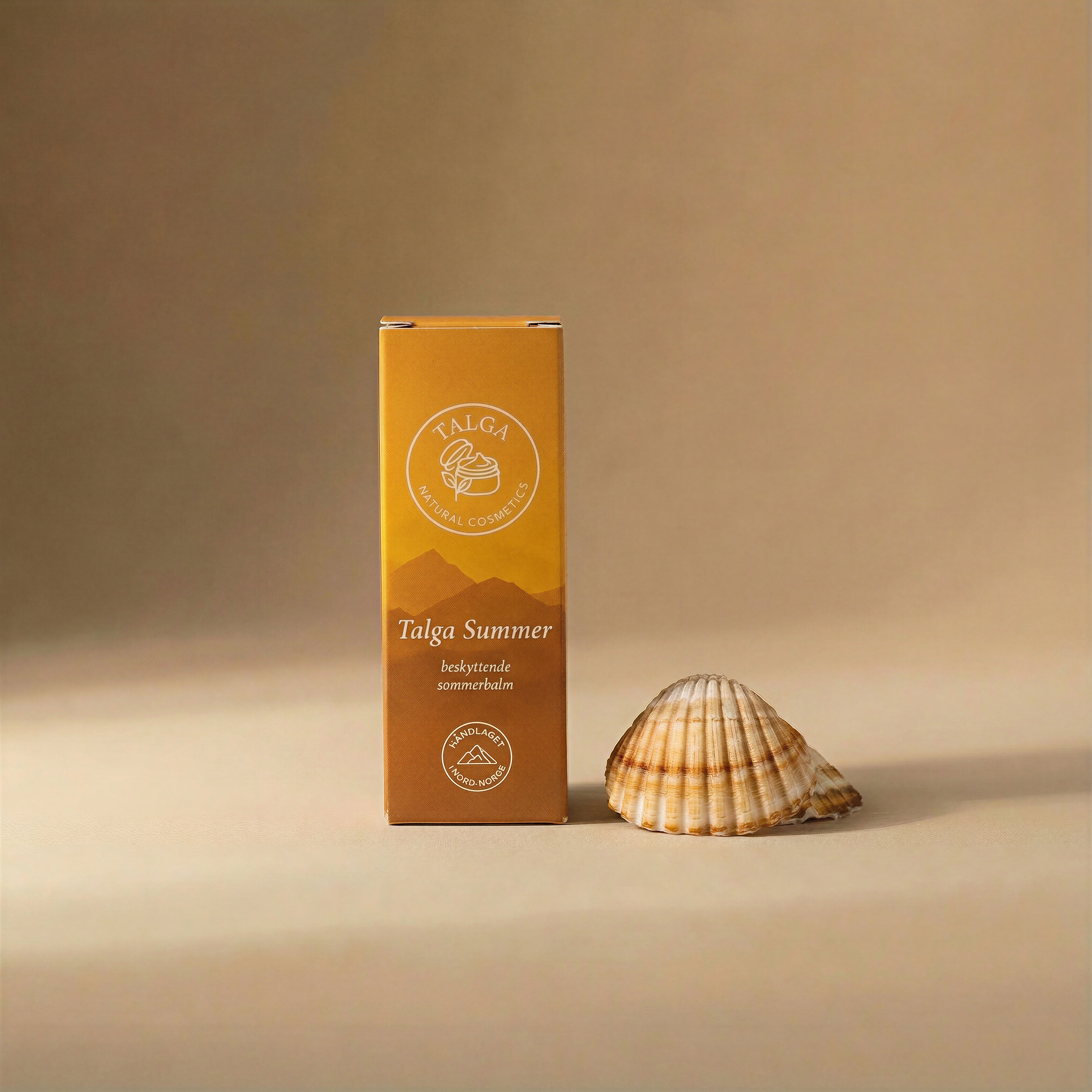Talga Summer protective balm box on a beige background next to a seashell.
